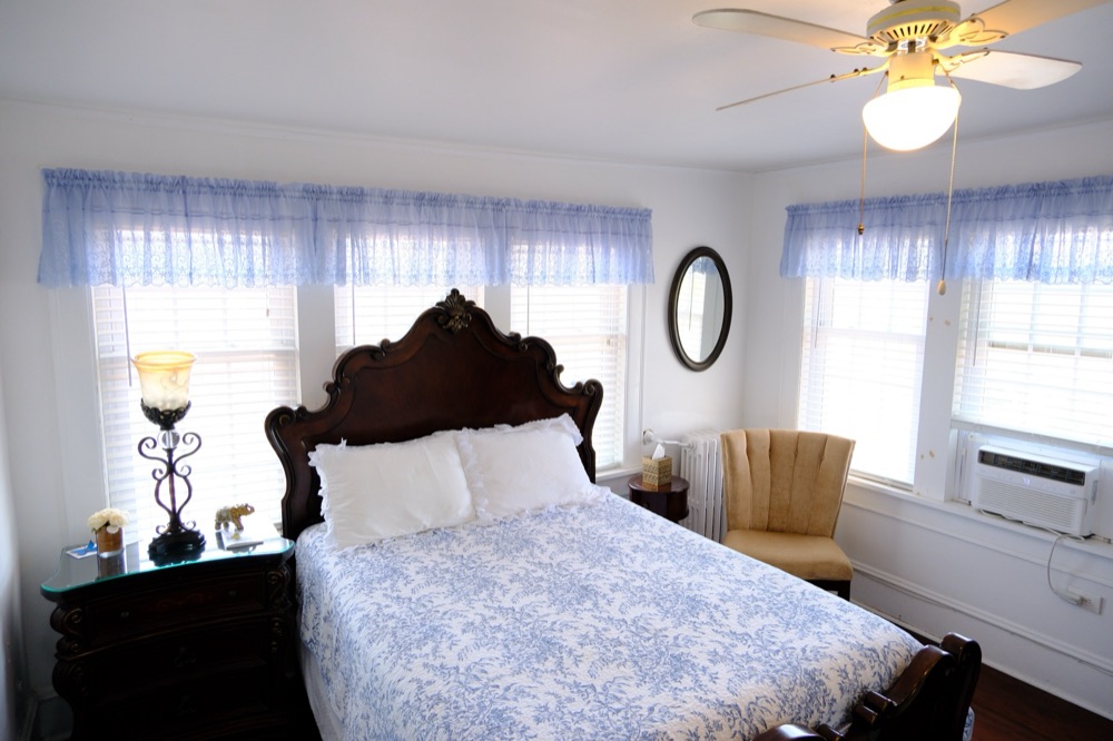 Guest room in blue toile with a gold accent chair